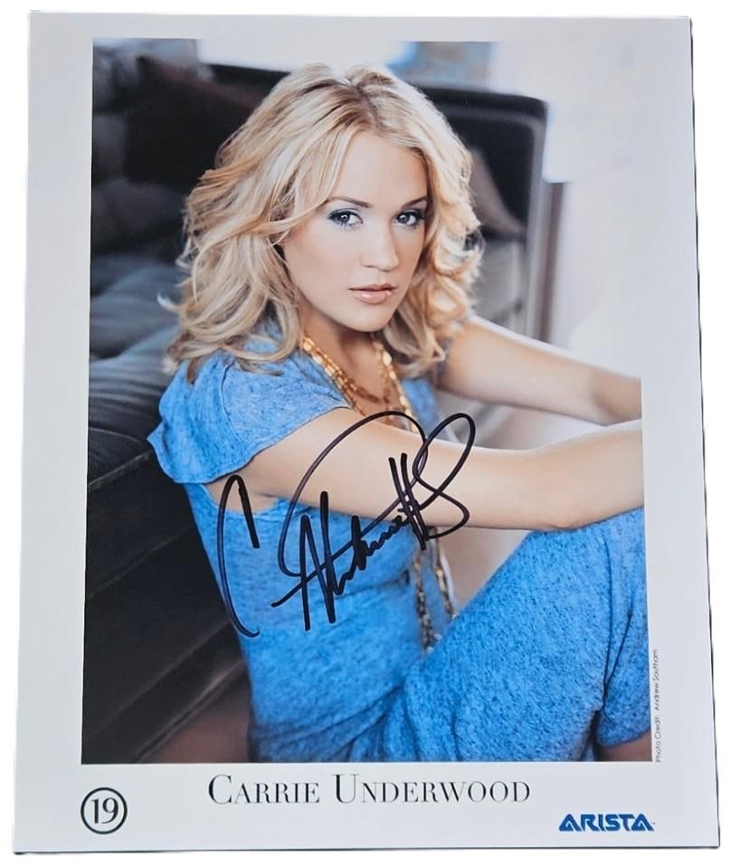Carrie Underwood Signed 10" x 8" Press Photo (Third Party Guaranteed): Color 10" x 8" press photo signed in black felt tip marker by country musician Carrie Underwood. In fine condition. Obtained in-person. Provenance Eaton & Brennan Auctions guarantees this lot to pass