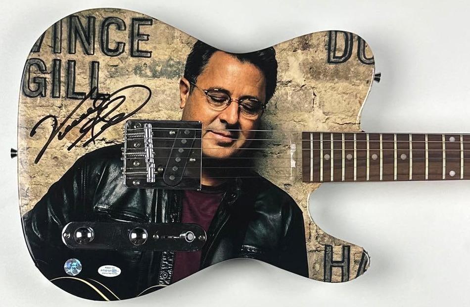 Vince Gill Signed Custom Graphics Telecaster-Style Signature Edition Guitar (ACOA): Vince Gill custom graphics Telecaster-style signature edition guitar signed on the body in black felt tip marker by musician Vince Gill. Measuring approximately 38.5" x 13" and in fine condition.