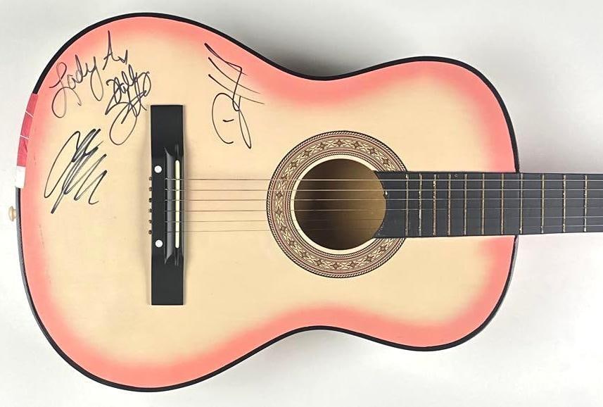 Lady Antebellum Group Signed Acoustic Guitar (3 Sigs; 2010 Meet & Greet Pass): Pink sunburst acoustic guitar signed on the body in black felt-tip marker by Lady Antebellum members Hillary Scott, Charles Kelley, and Dave Haywood. Scott additionally inscribed the band name
