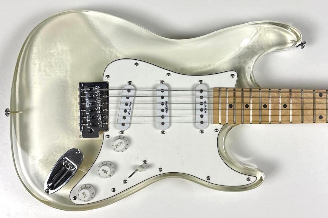 Transparent Acrylic Galveston Brand Stratocaster-Style Guitar: Transparent acrylic Galveston brand Stratocaster-style guitar. Measuring approximately 39.5" x 12.25" and in fine condition. Guitar accompanied by a hard case.