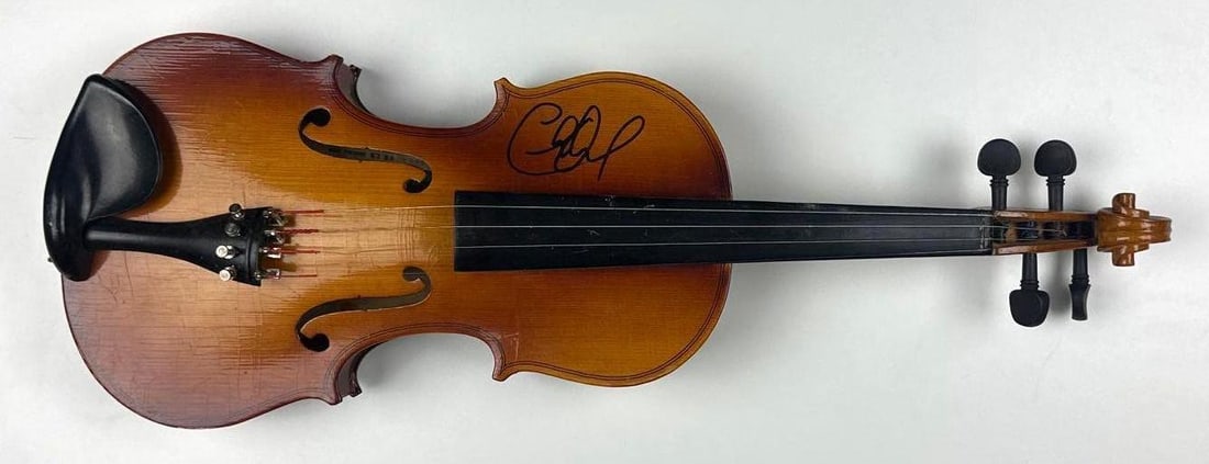Charlie Daniels Signed Wooden Fiddle (PSA/DNA Authentication): Wooden 23" x 8" fiddle signed on the upper body in black felt-tip marker by Charlie Daniels, best known for his signature hit, “The Devil Went Down to Georgia.” In very good condition,