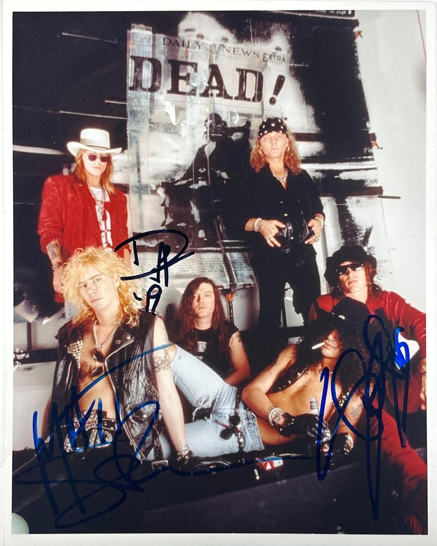 Guns N' Roses Group Signed 10" x 8" Photo (3 Sigs) Beckett Authentication): Color 10" x 8" photo signed in blue and black felt tip markers by Guns N' Roses band members Slash, Duff McKagan, and Matt Sorum. In fine condition. Accompanied by a full Letter of Authenticity from