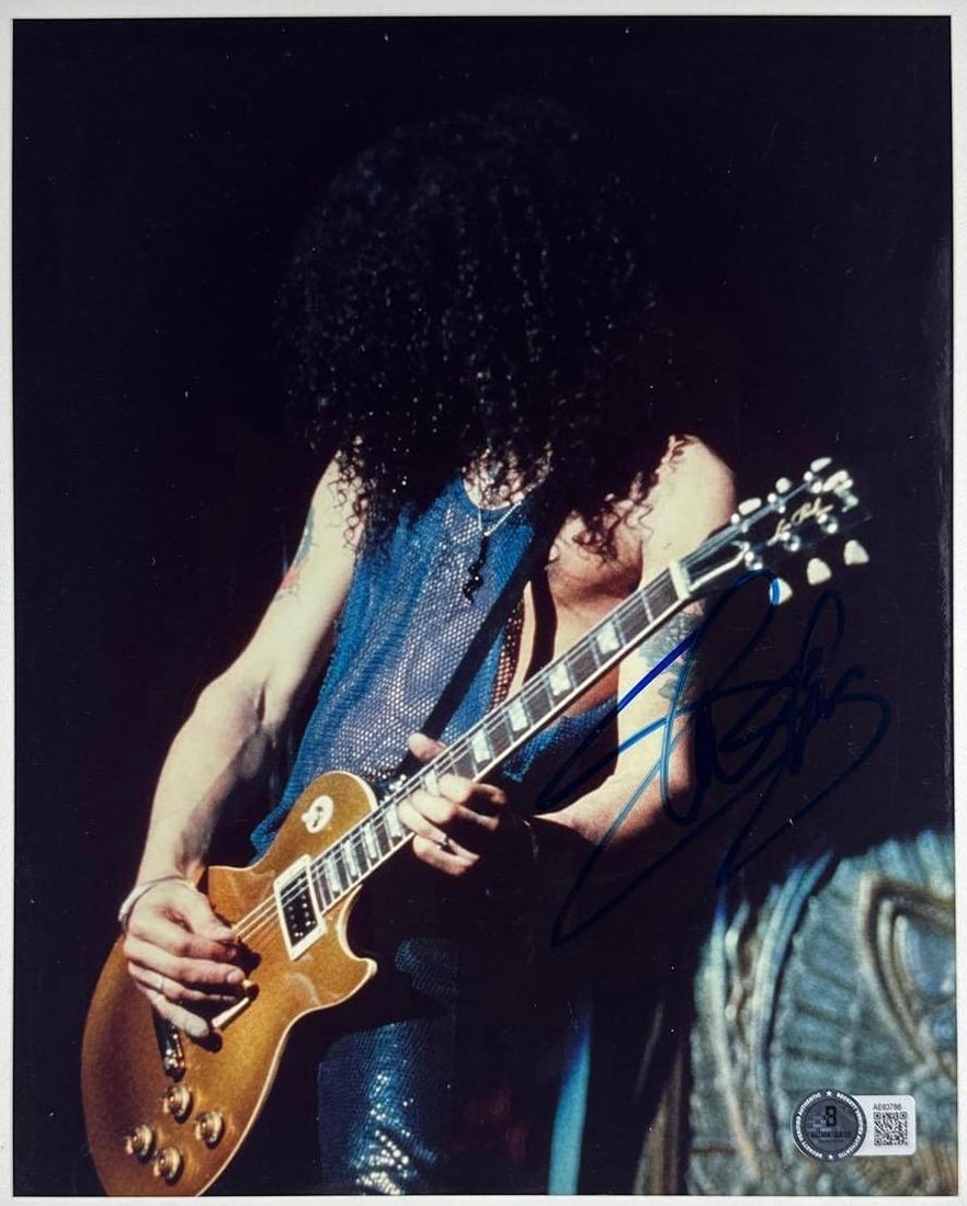 Guns N' Roses: Slash Signed 10" x 8" Photo (Beckett Authentication): Color 10" x 8" photo signed in blue felt tip marker by Guns N' Roses band member Slash. In fine condition. Accompanied by a full Letter of Authenticity from Beckett (#AE63786).