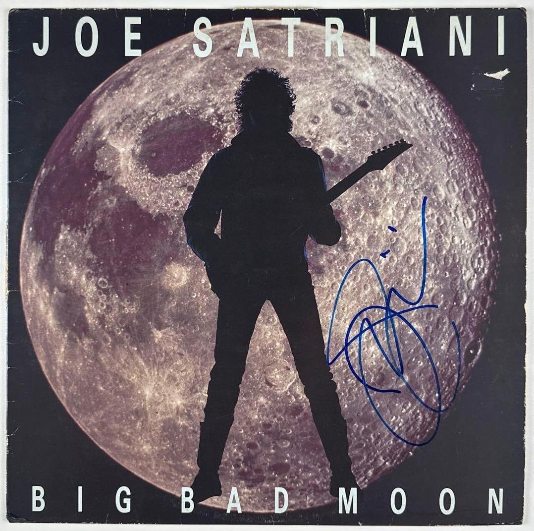Joe Satriani Signed "Big Bad Moon" Album (Third Party Guaranteed): "Big Bad Moon" album signed on the cover in blue felt tip marker by musician Joe Satriani. Measuring approximately 12" x 12" and in fine condition. Record is included. Provenance Eaton & Brennan
