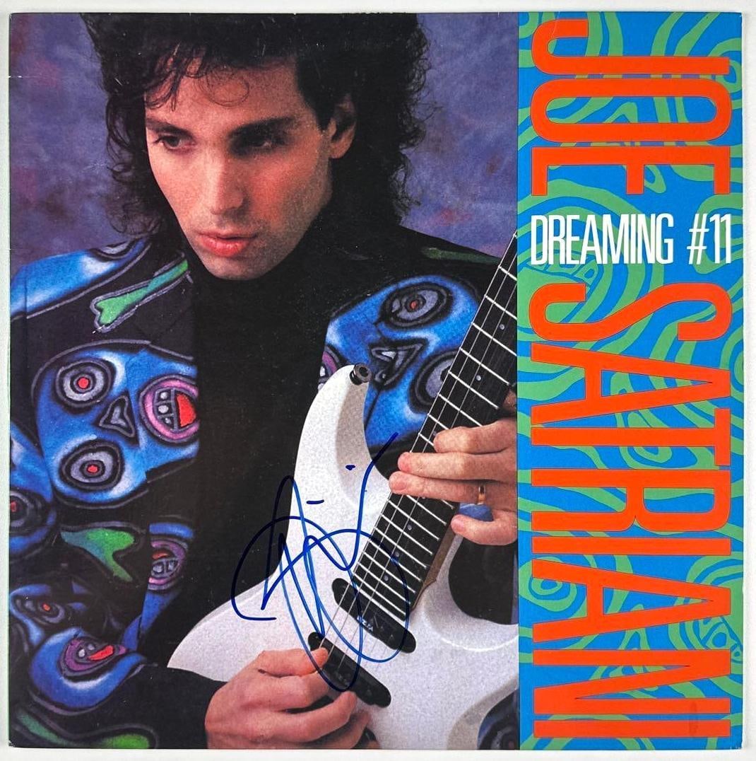 Joe Satriani Signed "Dreaming of #11" Album (Third Party Guaranteed): "Dreaming of #11" album signed on the cover in blue felt tip marker by musician Joe Satriani. Measuring approximately 12" x 12" and in fine condition. Record is included. Provenance Eaton & Brennan