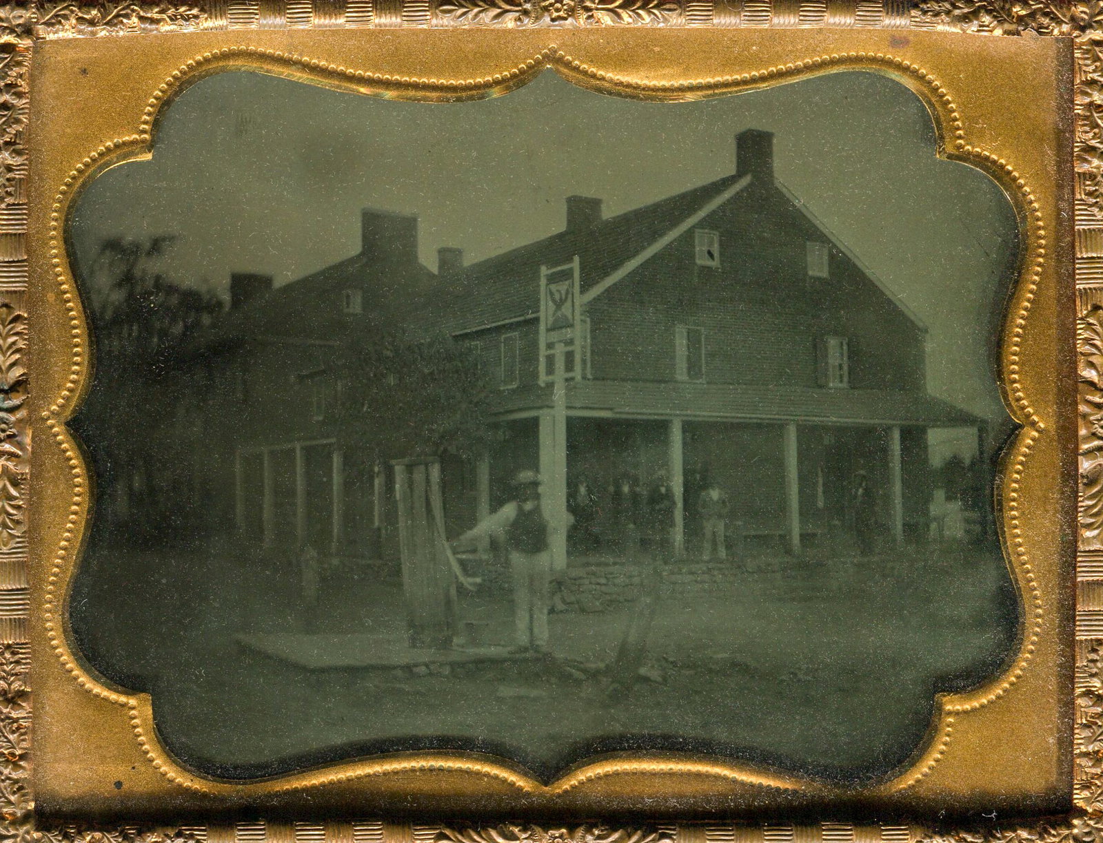 Sixth Plate Ambrotype of a Hotel with Vintage Pump: Transport yourself to a vibrant moment in history with this sixth plate ambrotype capturing a lively scene in front of a hotel, complete with a prominent pump and a bustling crowd on the porch. While