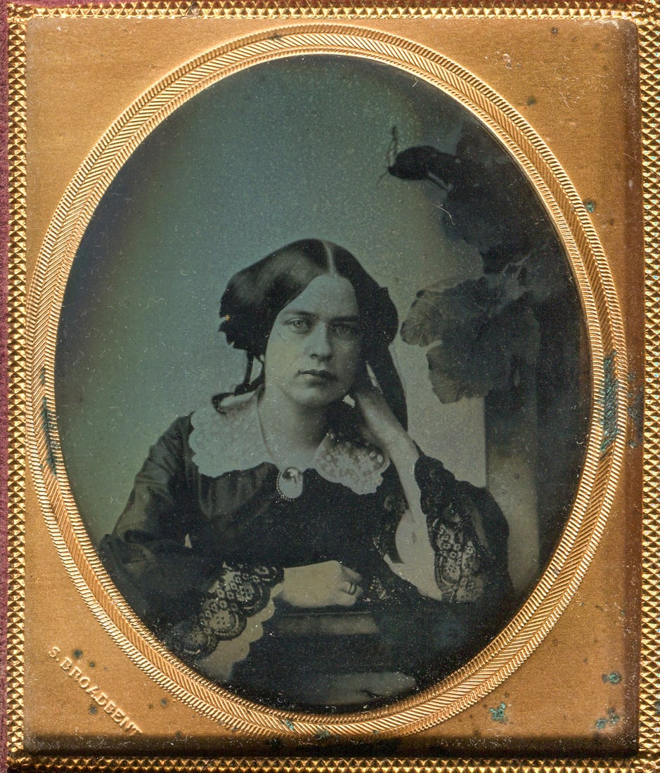 Ambrotype of a Woman, Signed by Broadbent: A captivating cased sixth plate ambrotype by Broadbent, renowned for his skillful portrayal of beautiful women. This ambrotype features the classic window and grapevine backdrop synonymous with Broadb
