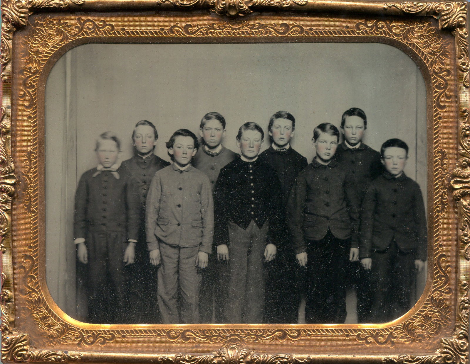 Ambrotype of a Group of 9 School Children: A captivating uncased half-plate ambrotype capturing a group of nine school children, presumably posed for a school photograph, frozen in time with remarkable clarity and detail. This evocative image