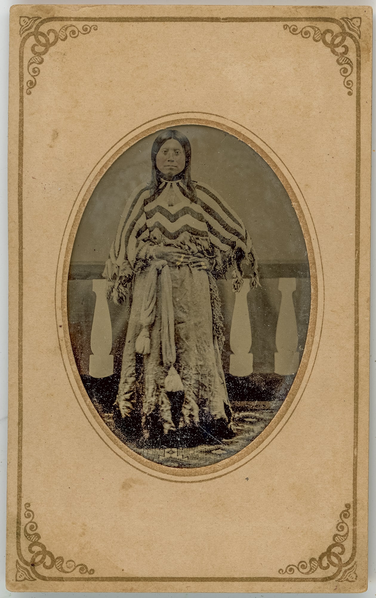 Tintype of Young Native American Girl by Strong and Sims: A captivating CDV-sized tintype studio portrait captured by Strong & Sims, Photographers, featuring a young Native American girl. In this striking image, the girl stands in full figure, exuding an air