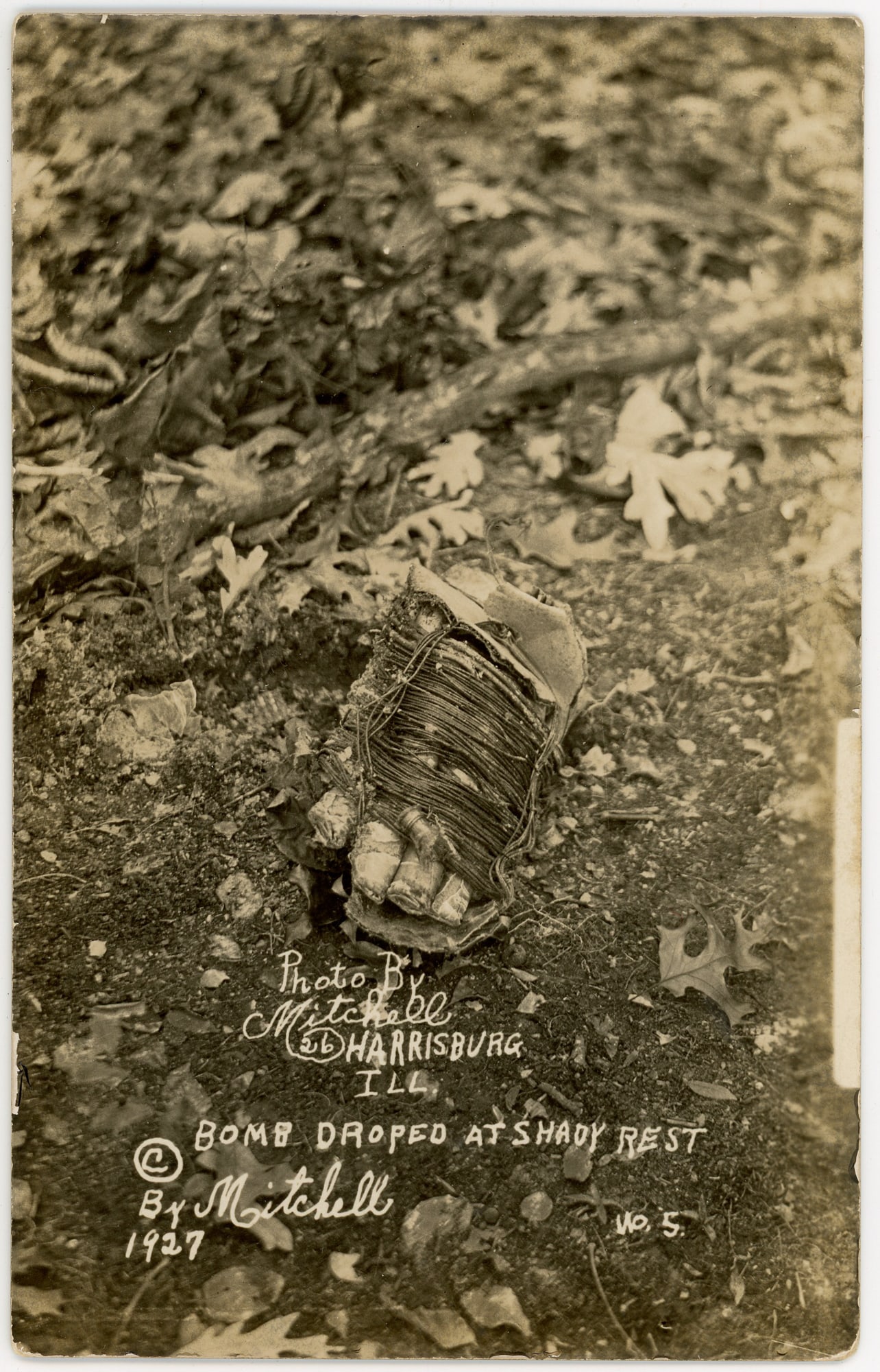 Real Photo Post Card of The Bombing of Charles Birger's Gang: A remarkable piece of historical documentation: a real photo postcard capturing the aftermath of the bombing of Charles Birger's gang, titled "Bomb Dropped at Shady Rest." This rare postcard offers a