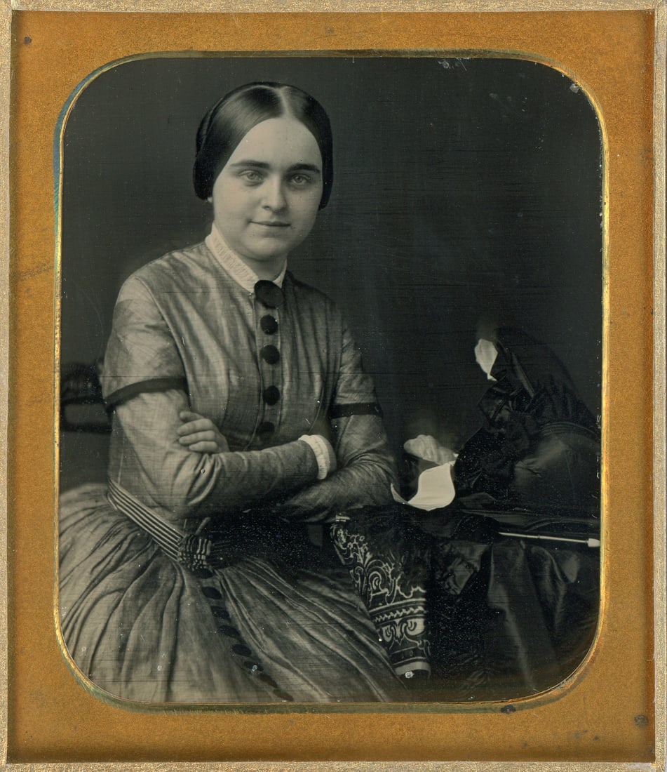 Daguerreotype By Root of Young Beautiful Woman with Bonnet: A sixth plate daguerreotype by Root Gallery in Philadelphia of an identified young beautiful woman, Bessie Penington 21 years, with a bonnet delicately placed on a table. This exquisite piece offers a