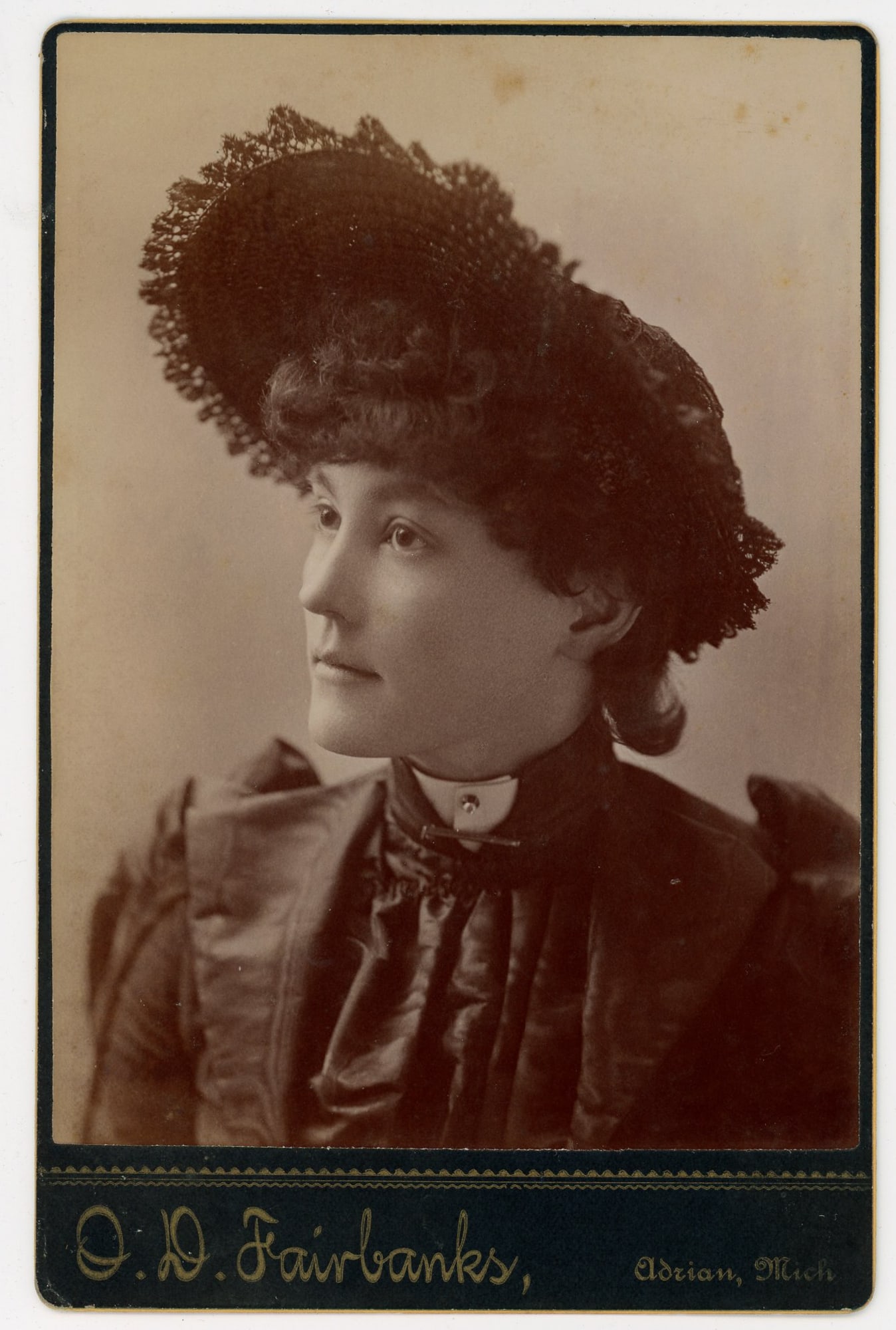 Photographer’s Wife Cabinet Card by O.D. Fairbanks: Albumen cabinet card portrait of a young woman identified on the reverse in pencil as “Mrs. O.D. Fairbanks,” the wife of Adrian, Michigan photographer O.D. Fairbanks, circa 1890s. The sitter i