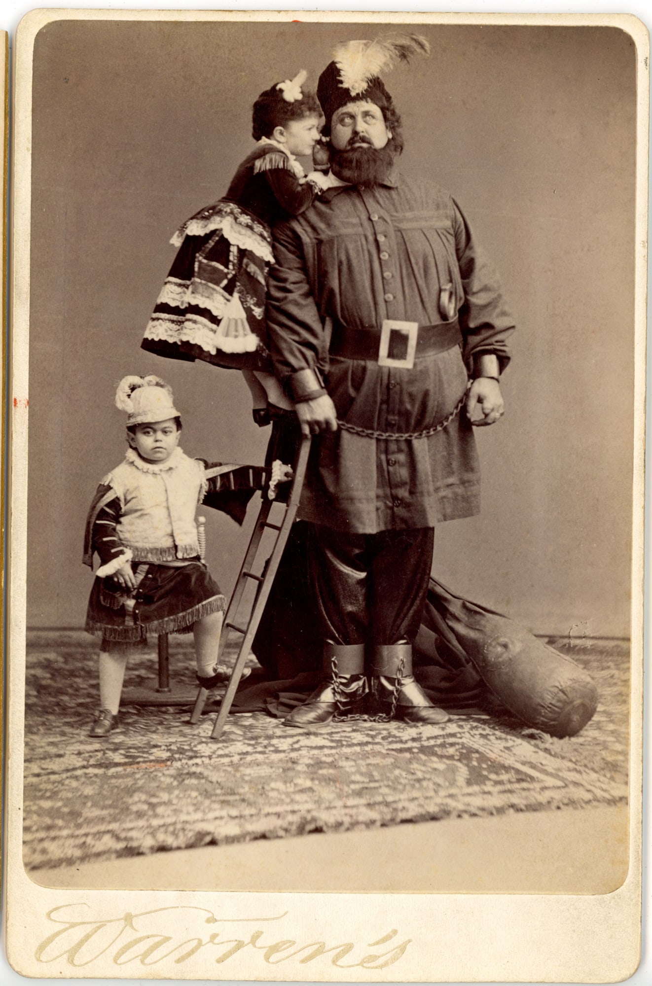 Cabinet Card Admiral Dot & Jennie Quigley Circus Performers: Cabinet card photograph depicting the well-known little person performer Admiral Dot (Leopold Kahn) standing in costume beside two young girls identified as Jennie Quigley and another child performer.