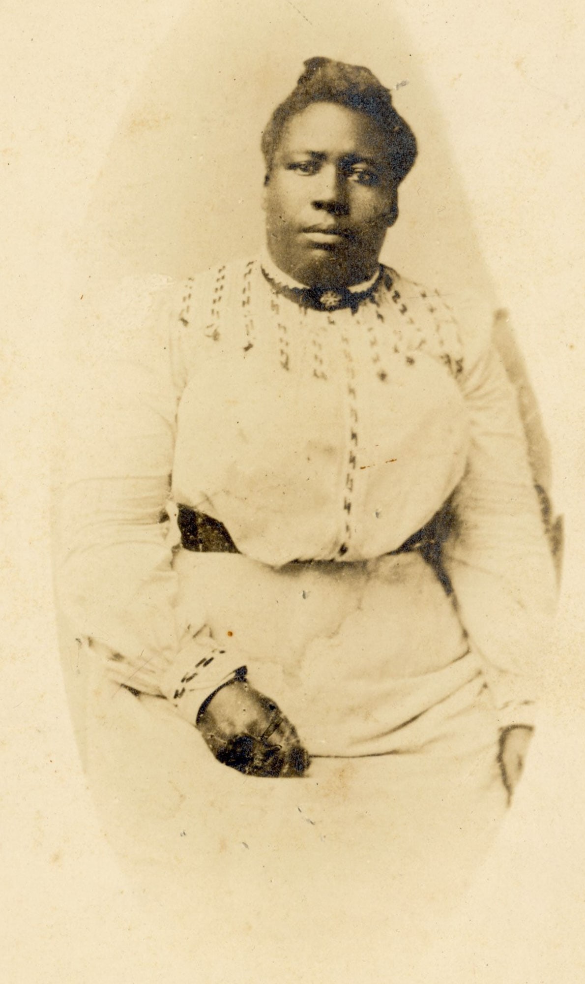 Mounted photo of African American Jane Carter, Brooklyn NY: A seated black woman identified on the reverse as Jane Carter is portrayed in this gelatin silver mounted photo measuring 8" by 6" produced by Jackson & Co. at 222 Court Street, Brooklyn, New York, ci