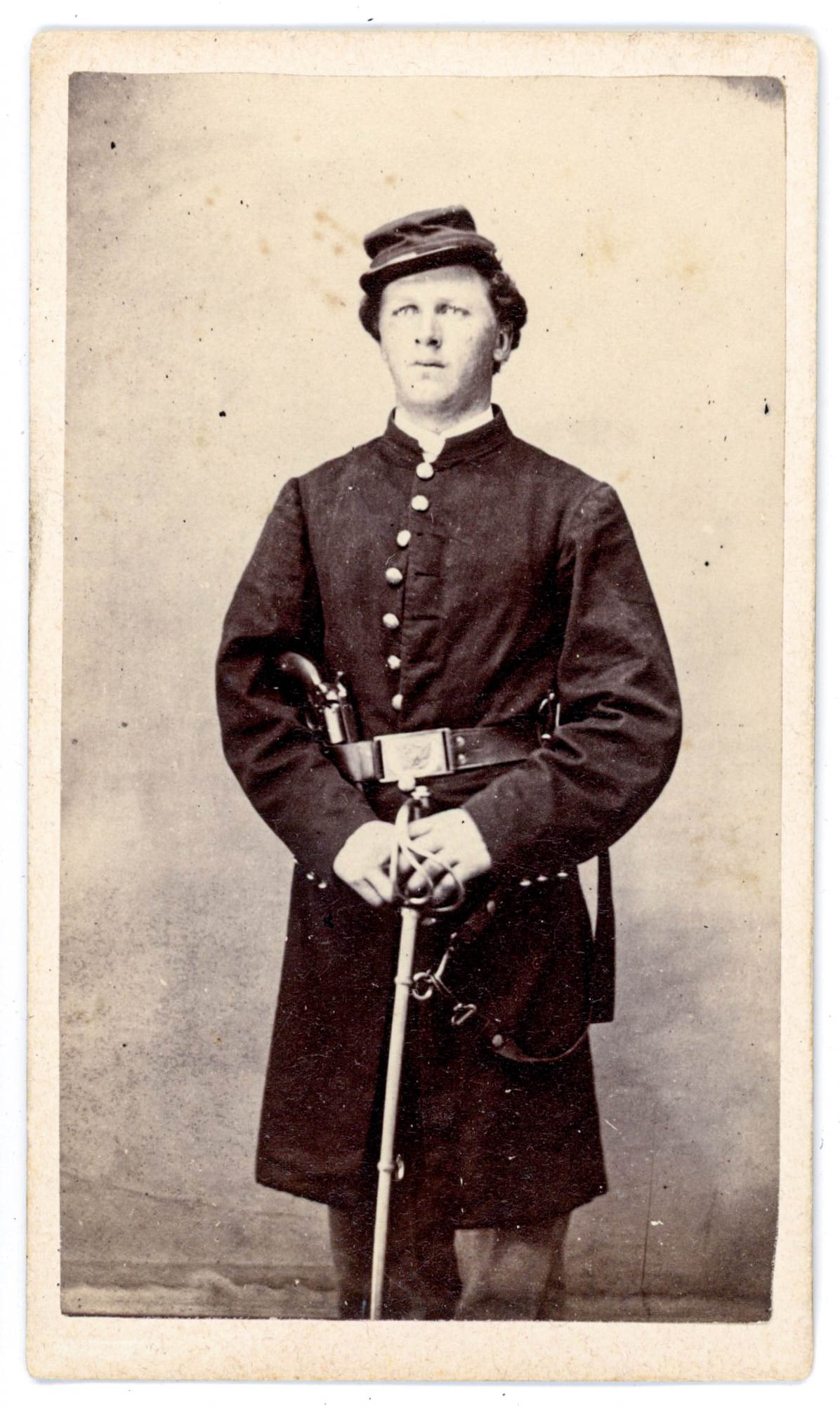 CDV, Unidentified Double-Armed Civil War Cavalry Officer: An unidentified Union soldier stands at full length in this albumen CDV with no photographer's imprint produced during the Civil War era. He faces the camera directly with a composed, forward expressi