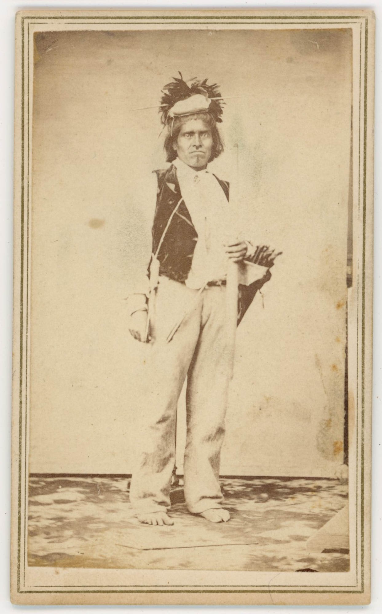 CDV, Capt. Lambazo, Native American Portrait, c. 1860s: Capt. Lambazo is portrayed in a full-length standing studio pose in this CDV dating to the 1860s, identified by ink inscription on the reverse in a hand consistent with the period. The subject is pres