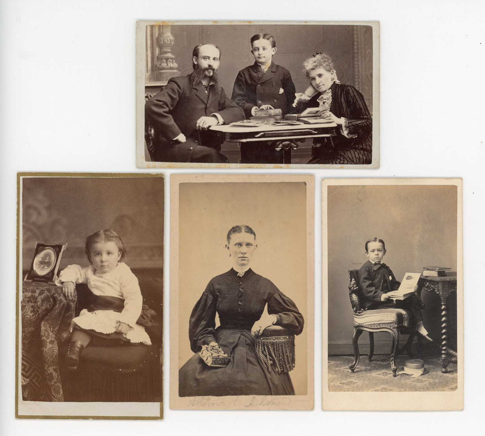 CDV Group, Individuals Looking at Photographs, Four Examples: Four albumen carte-de-visite portraits comprise this lot, dating to the 1870s through 1880s and produced by studios in Michigan, Wisconsin, Massachusetts, Connecticut, and Hamburg, Germany. The larges