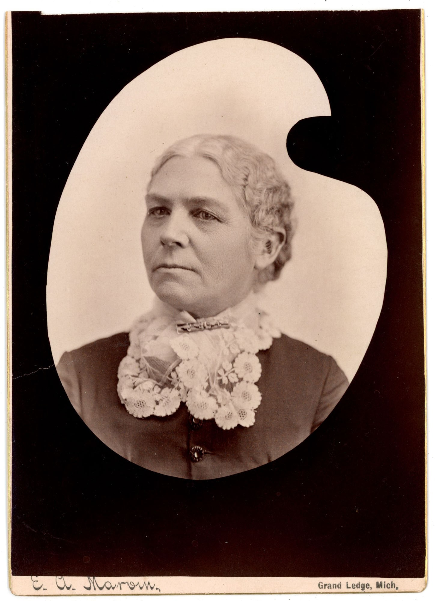 Cabinet Card, Unidentified Woman, E.A. Marow, Grand Ledge MI: An unidentified middle-aged woman is portrayed in a bust-length portrait within an artist's palette-shaped image window on this cabinet card attributed to E.A. Marow of Grand Ledge, Michigan, with the