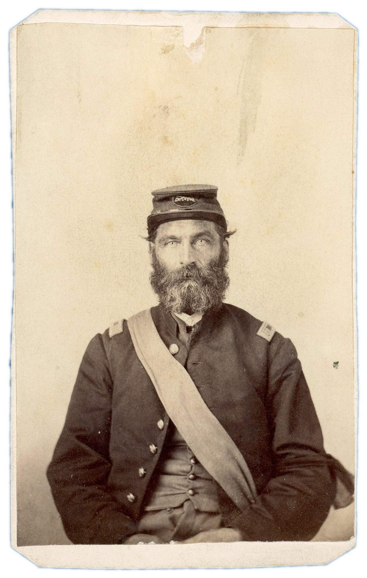 CDV, Capt. J. Mo. Gates, Iowa Civil War Soldier: Capt. J. Mo. Gates, an Iowa Civil War soldier, is portrayed in this albumen CDV produced during the 1860s. The half-length seated pose, plain pale backdrop, and card format are consistent with studio