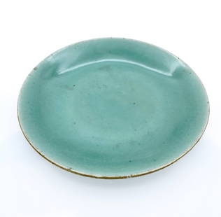 Chinese Qing Dynasty Green Celadon Glazed Circular Plate: Circular porcelain dish with a soft green celadon glaze, attributed to the Qing Dynasty. The glaze has a subtle translucency and even pooling, especially around the everted rim and recessed base. The