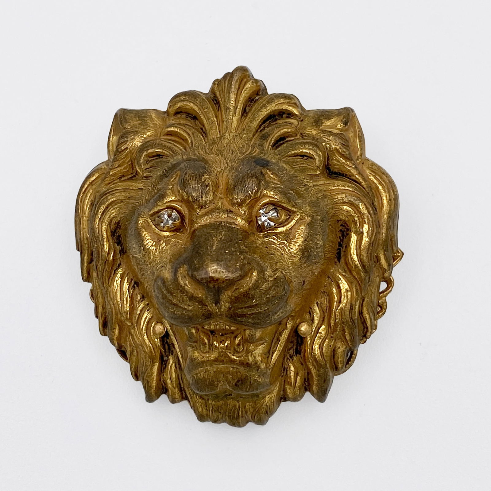 Miriam Haskell Lion Pin: Vintage Miriam Haskell Lion goldtone pin w/ crystal eyes. Branded label on reverse. 1.5" x 1.5"