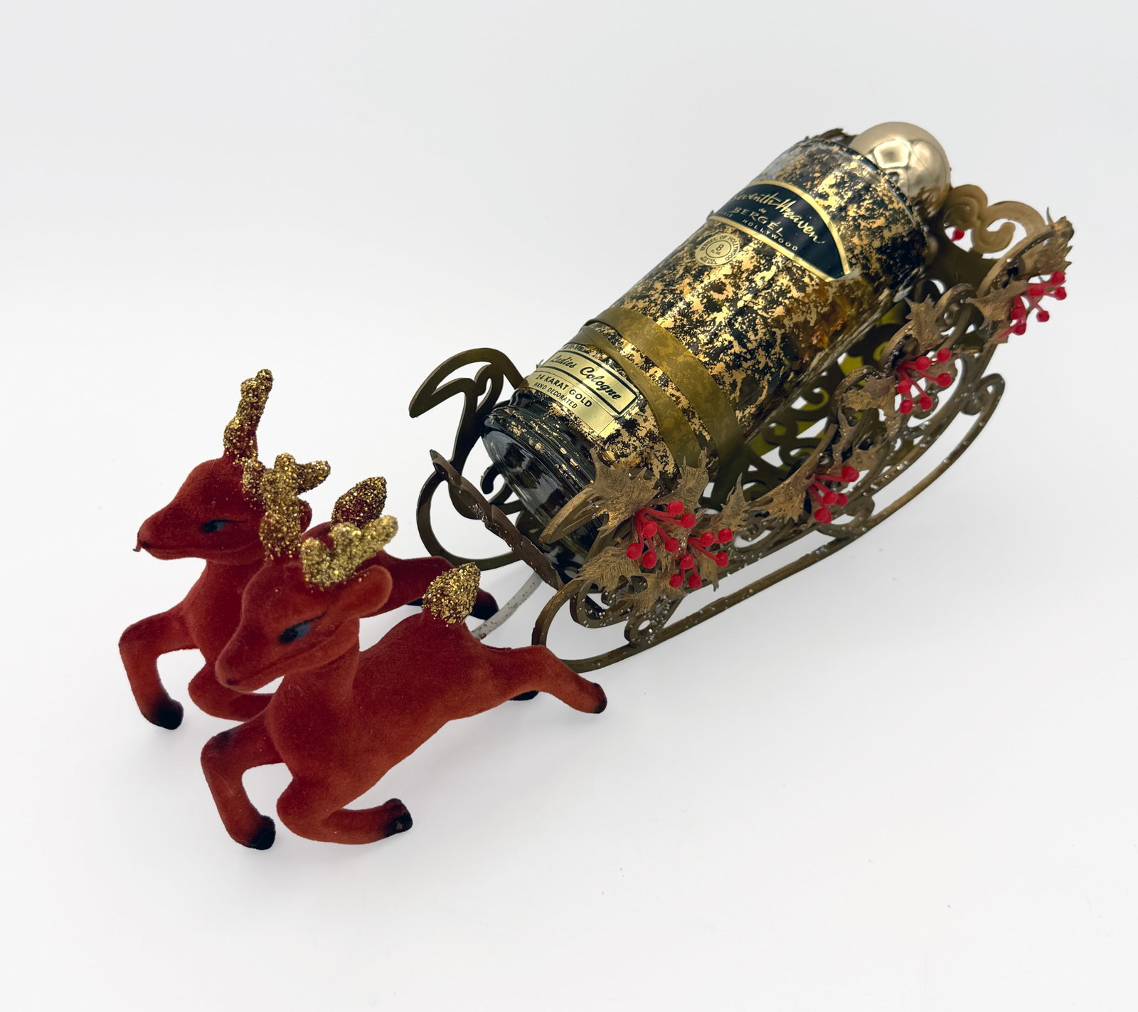 RARE 1945 Christmas Ed. Seventh Heaven perfume: VERY RARE!! Vintage 1945 Special Christmas Edition Seventh Heaven perfume New unopened in a beautiful 24kt gold distressed 8oz bottle by Bergel of Hollywood nested in a gold and red theme sleigh pulle