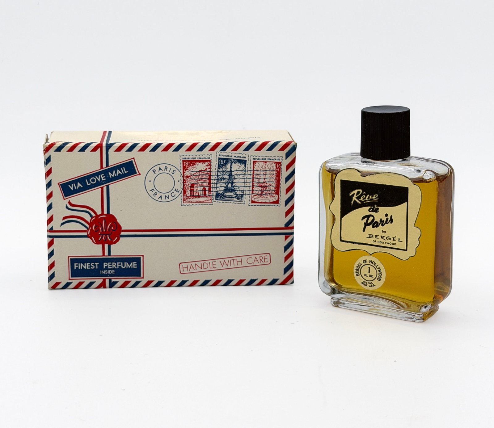 Vintage Reve de Paris perfume 1 fl oz: Vintage Reve de Paris perfume by Bergel of Hollywood - 1 fl oz new in box. 3 available. One bottle has postcard graphic box variant, the remaining two bottles come in standard white box with black edg