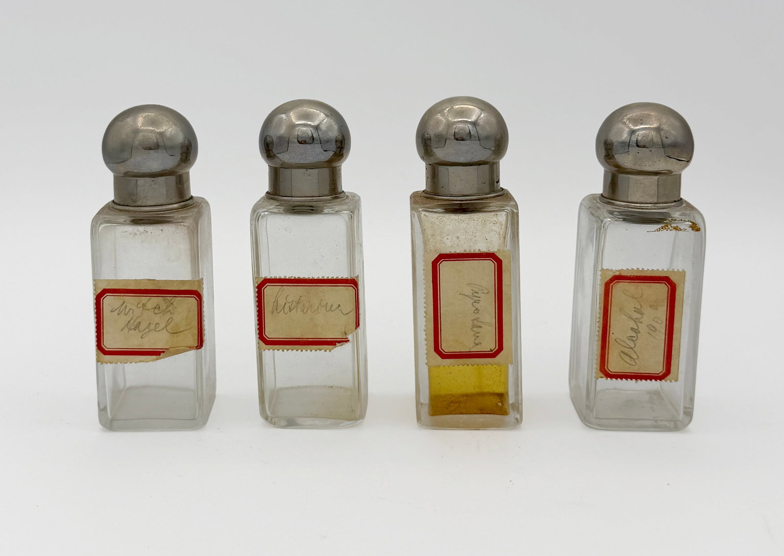 Vintage travel apothecary case w/ 4 bottles: Vintage travel apothecary case w/ 4 bottles. Case is leather and well used but structurally sound. Glass bottles have metal stopper tops and vintage labels for Witchhazel, Alcohol, and Listerine.