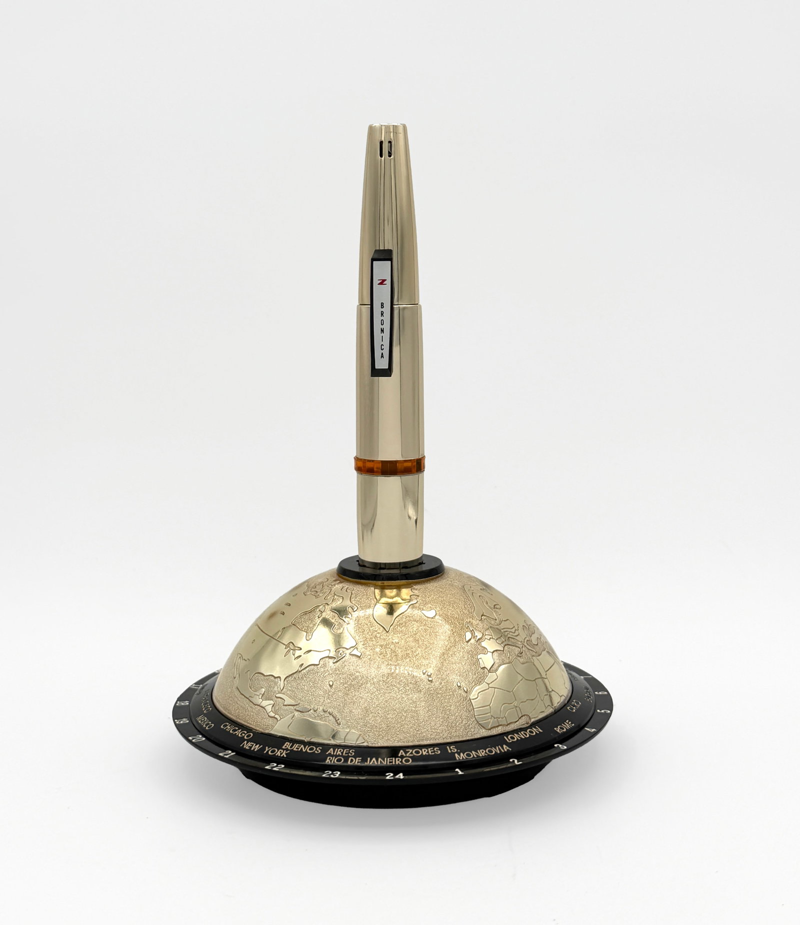 Vintage Bronica Worldtime gas table lighter NIB: Vintage 1960s Bronica gas table lighter, unused in its original box. The lighter is mounted on a globe-form base displaying international time zones. Dead stock. Three available, sold separately.