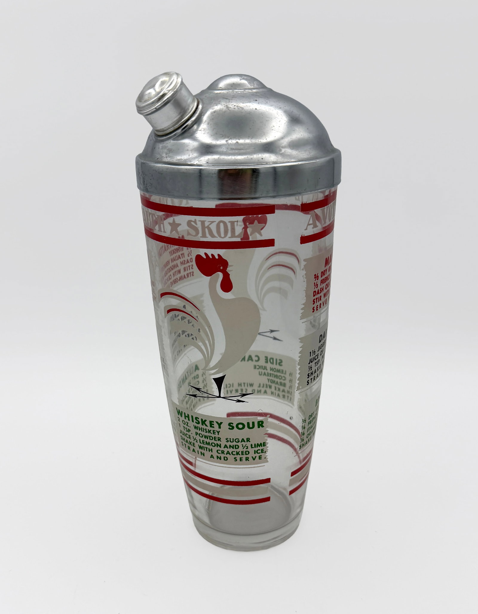 Vintage Cocktail Shaker Skol 8 Recipes Rooster: Vintage Skol To your Health Drink Shaker Barware with 8 recipes and Rooster design. No chips or cracks. No paint loss. Glass stands 8" tall by 3 3/4" wide. Approximately 9 1/2" tall with lid on.