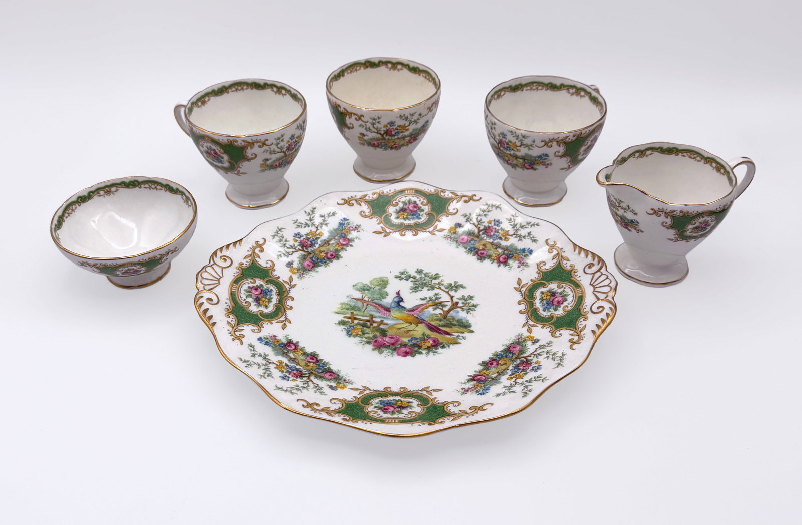 Foley Broadway Green Bone China Tea set (17pcs): Foley Bone China tea set, produced by E.B. & Co. between 1936 and 1948. “Broadway” pattern, adorned with floral bouquets and birds, set against a green border and accented gold trim.- 1 cake p