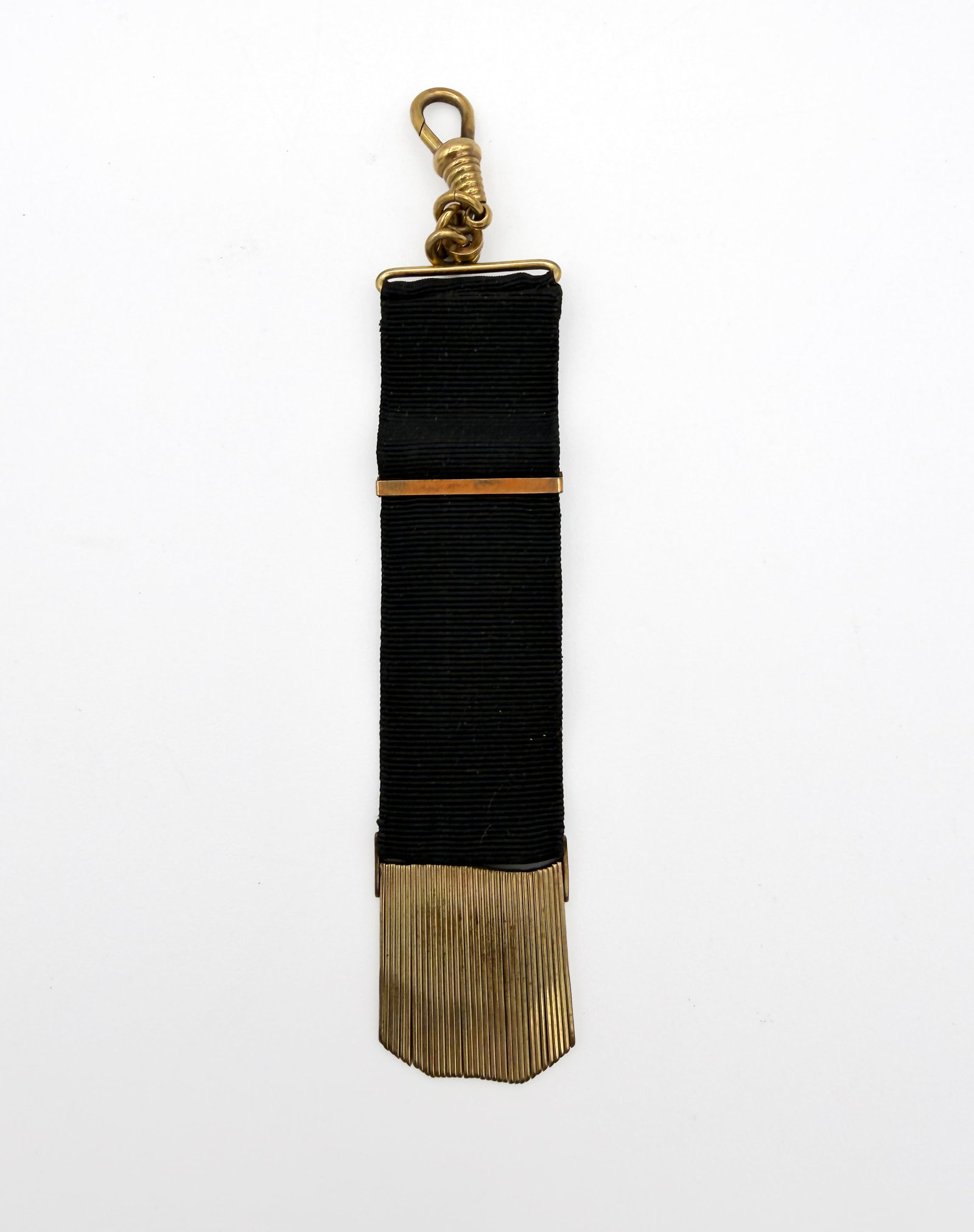 Victorian Mourning Ribbon Pocket Watch Fob: Late 19th-century Victorian mourning-style pocket watch fob composed of black ribbed grosgrain ribbon with gold-tone metal fittings. Features a sliding ribbon keeper, short link chain, swivel dog-clip