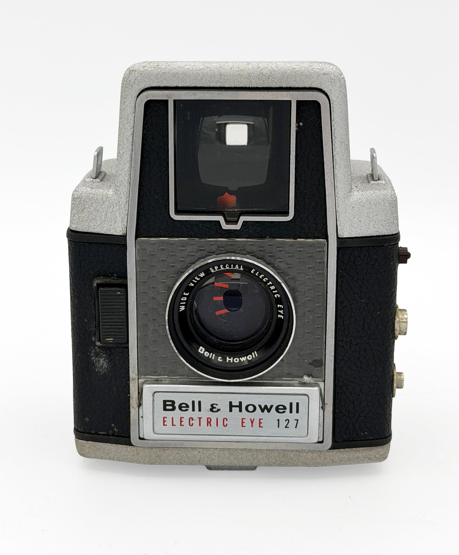 Bell & Howell Electric Eye 127 Box Camera: Bell + Howell Electric Eye cameraCa.1958.Vintage cast metal-bodied, medium format box camera. It takes 127 roll film, for 4x4 images. In good used condition, the lens and body do show signs of ageing,