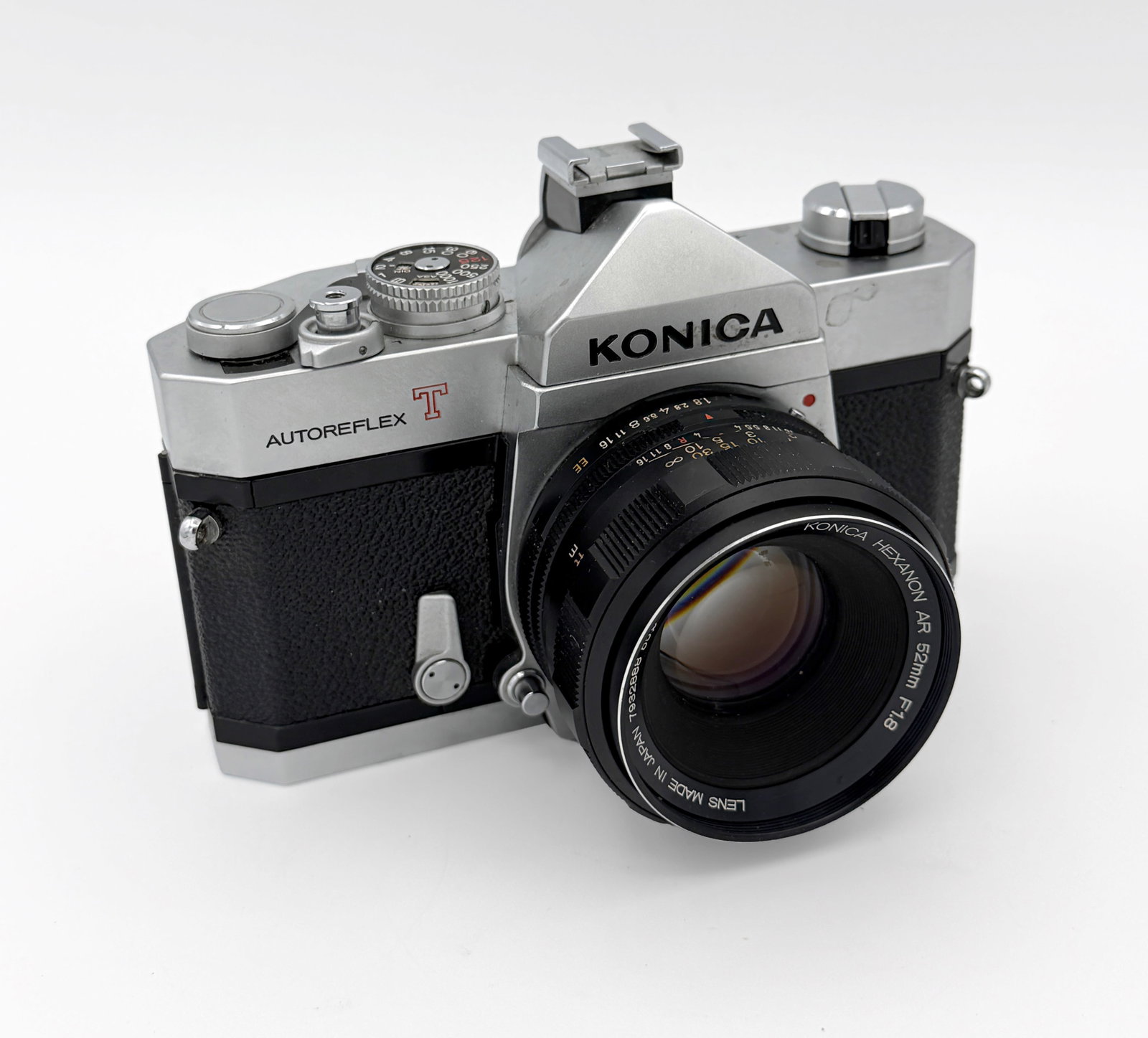 Konica Autoreflex T2 SLR w/ 52mm Lens: Konica Autoreflex T2 35mm single-lens reflex camera, manufactured in Japan circa 1970–1973, with a Konica Hexanon AR 52mm f/1.8 standard lens. The chrome-and-black camera features through-the-lens