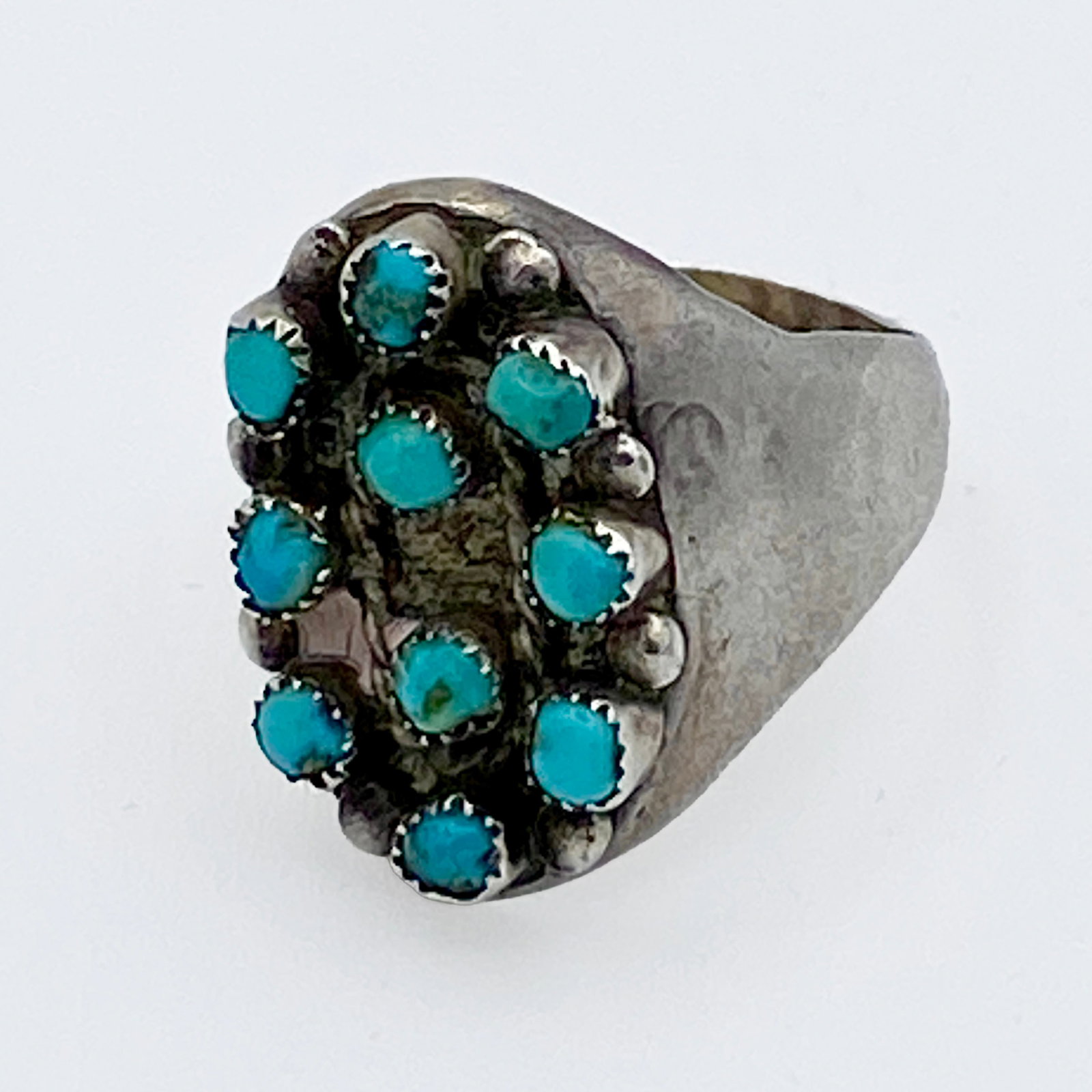 Vintage Turquoise Cluster Ring: Vintage sterling silver ring featuring a cluster arrangement of natural turquoise stones in a classic Southwestern/Navajo-inspired design. The ring is set with multiple small turquoise cabochons, each