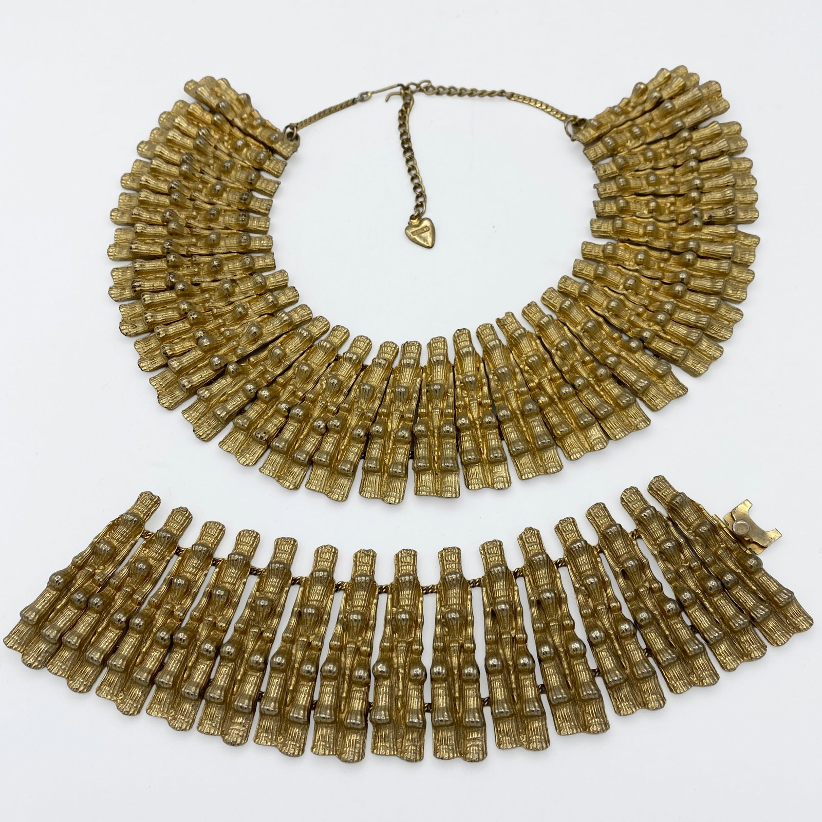 Mosela Bib Necklace & Bracelet: Vintage Mosell gold-tone necklace and bracelet set featuring a bold articulated bib/collar design with matching bracelet. The sculptural repeating elements create a strong, dimensional look with an