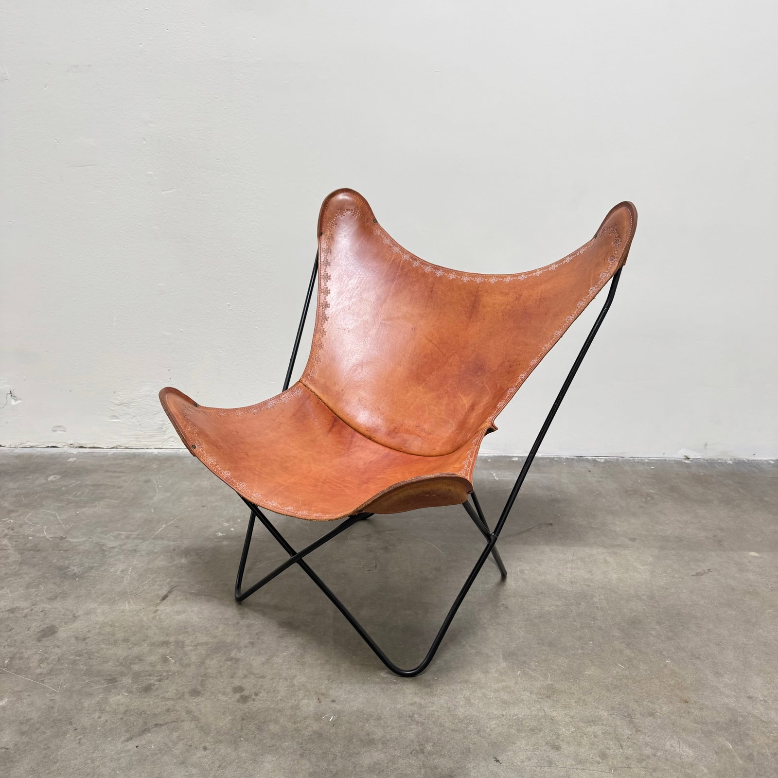 Leather and Iron Butterfly Chair, USA circa 2000: Classic MCM Style Butterfly chair in leather with iron frame. Height: 37" Width: 35" Depth: 34"
