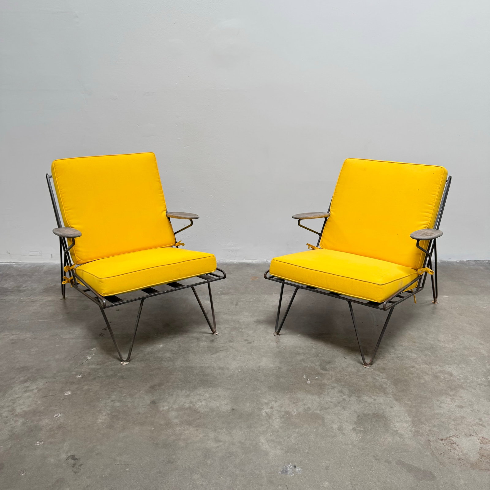 Pair of Yellow MCM Hairpin Outdoor Lounge Chairs, France circa 1950: Matching pair of yellow MCM hairpin outdoor lounge chairs with an iron frame. Height: 37" Width: 33" Depth: 25"
