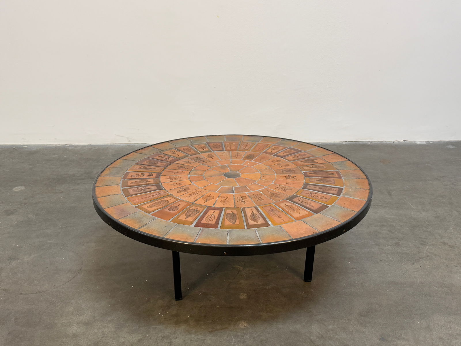 Round Ceramic Coffee Table with Herbarium Tiles by Roger Capron: Roger Capron coffee table Signed featuring Garrigue tiles, a technique in which real leaves from la garrigue, a variety of vegetation indigenous to southeastern France only, are pressed into the clay