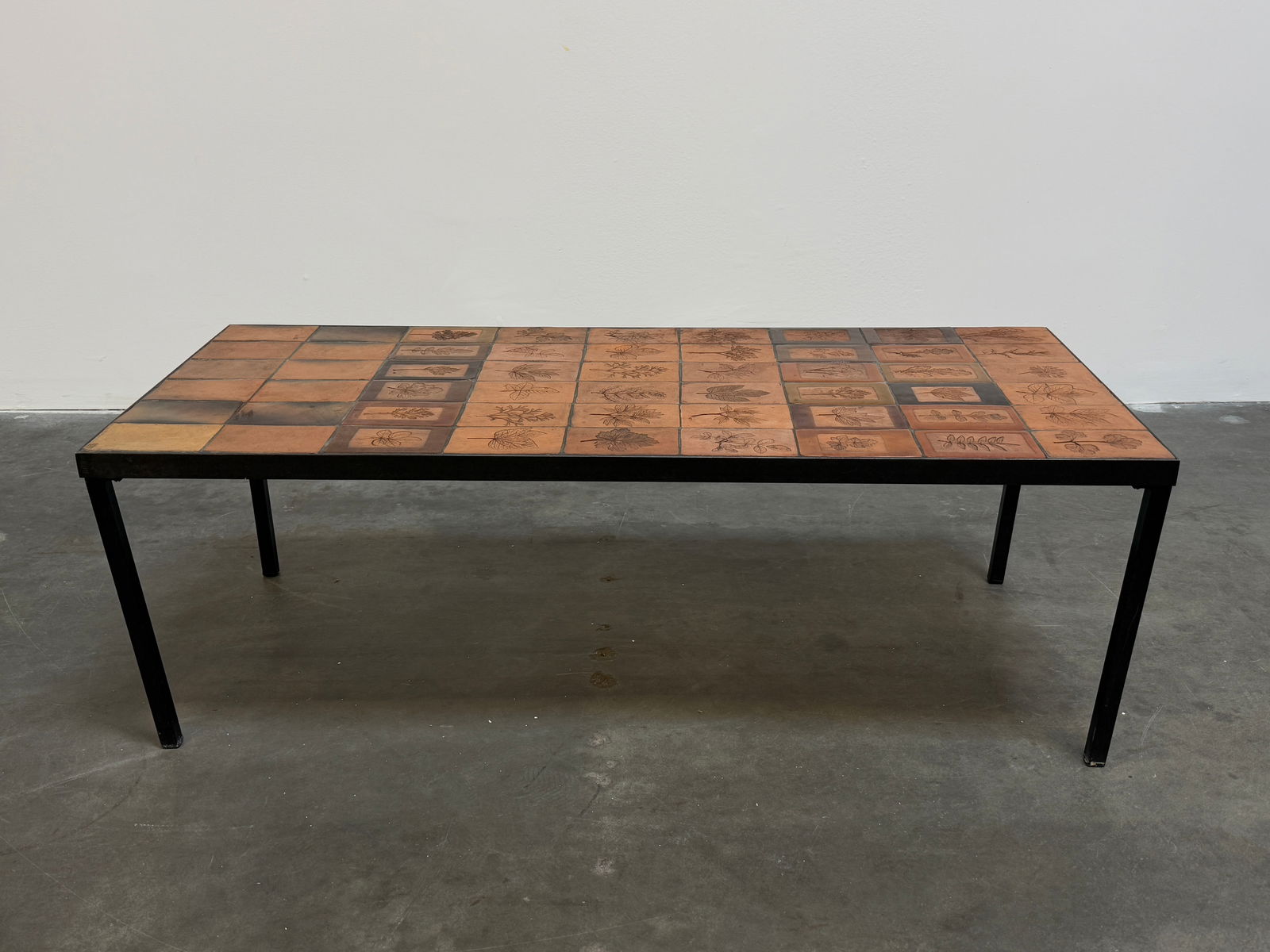 Large Ceramic and Floral Coffee Table by Roger Capron: Roger Capron coffee table signed featuring Garrigue tiles, a technique in which real leaves from la garrigue, a variety of vegetation indigenous to southeastern France only, are pressed into the clay