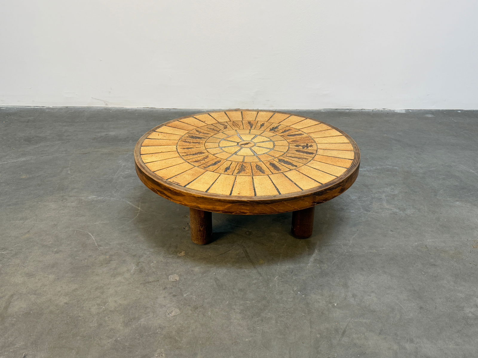 Roger Capron Small Ceramic Coffee Table: A charming small ceramic coffee table by Roger Capron, showcasing a meticulously tiled top with warm earthy tones. A refined example of Capron's craftsmanship. Height: 11 in. Width: 31 in. Depth: