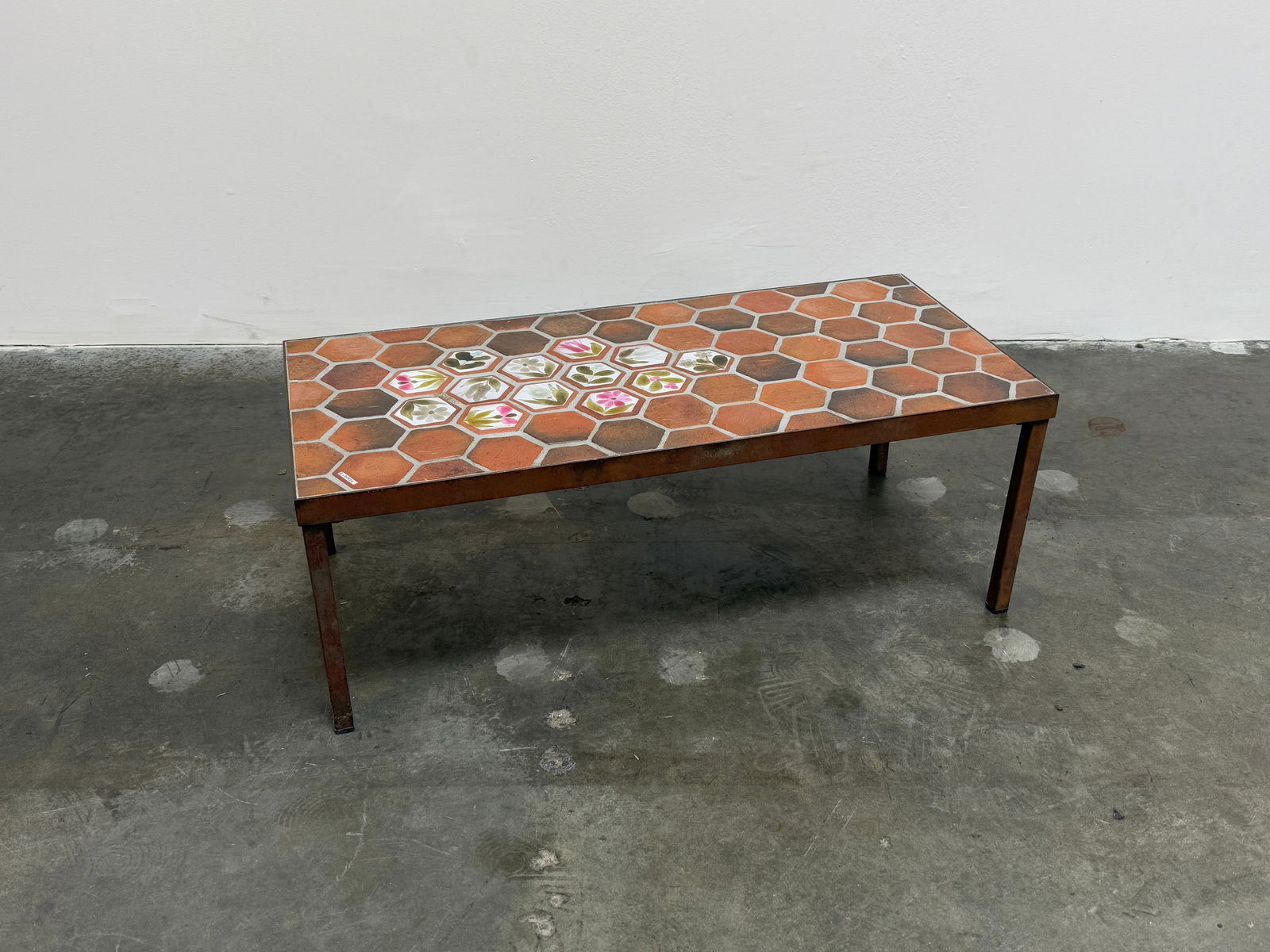 Ceramic Coffee Table Adorned with Flowers Painted by Roger Capron: A stunning ceramic coffee table by Roger Capron, decorated with hand-painted floral motifs. Height: 12 in. Width: 32 in. Depth: 16 in.