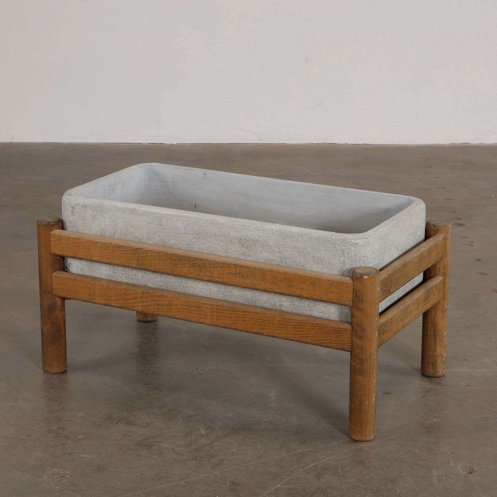 1960s French Concrete Rectangular Planter With Wood Stand: 1960s French rectangular concrete planter with a weathered finish, elegantly elevated on a wooden stand. A minimalist and striking planter for indoor or outdoor use. Height: 17 in. Width: 32 in. Depth