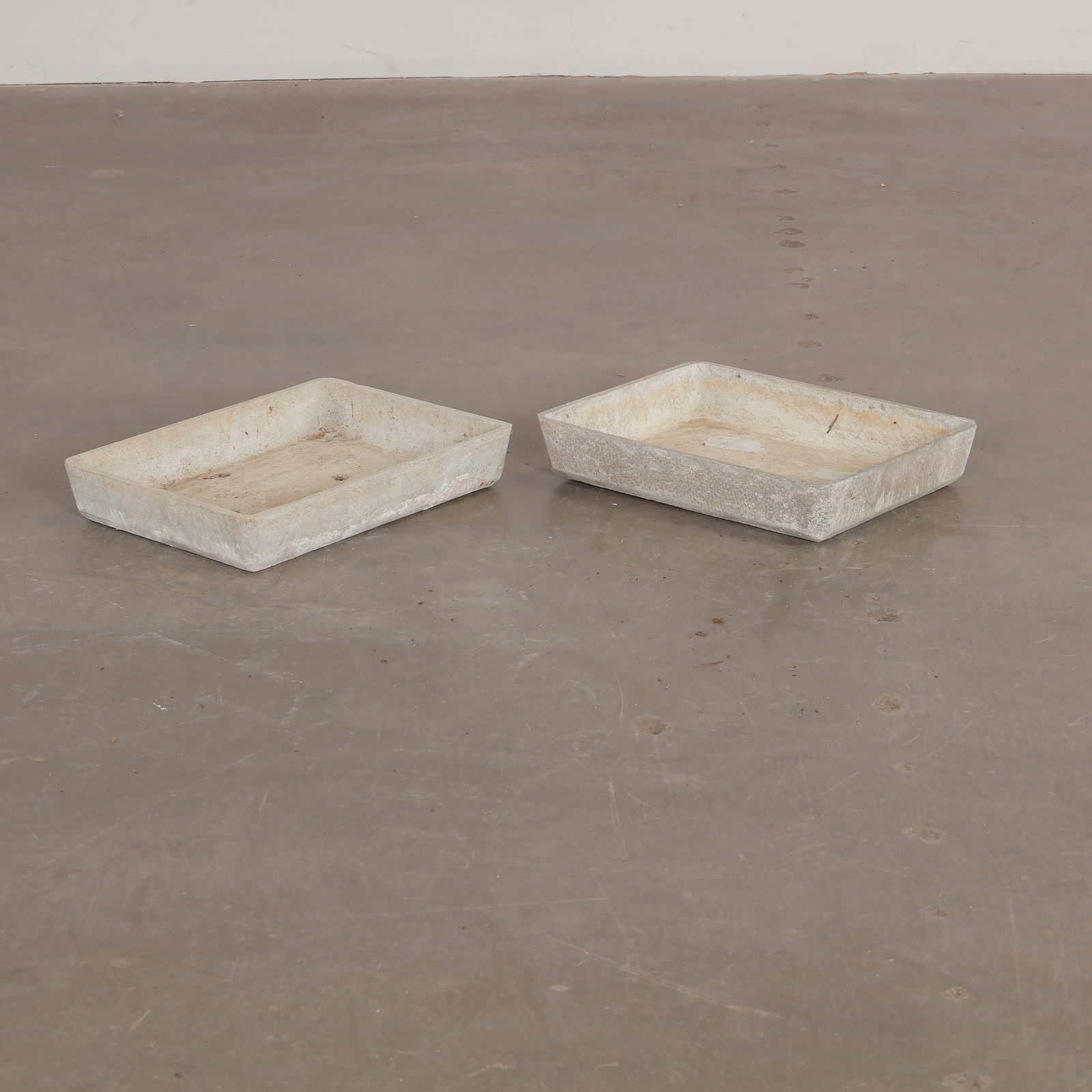 Pair of Willy Guhl Tray Planters, 1960s: Minimalist concrete trays by Willy Guhl. Sculptural, utilitarian pieces perfect for indoor or garden use. Height: 3 in. Width: 16 in. Depth: 12 in.