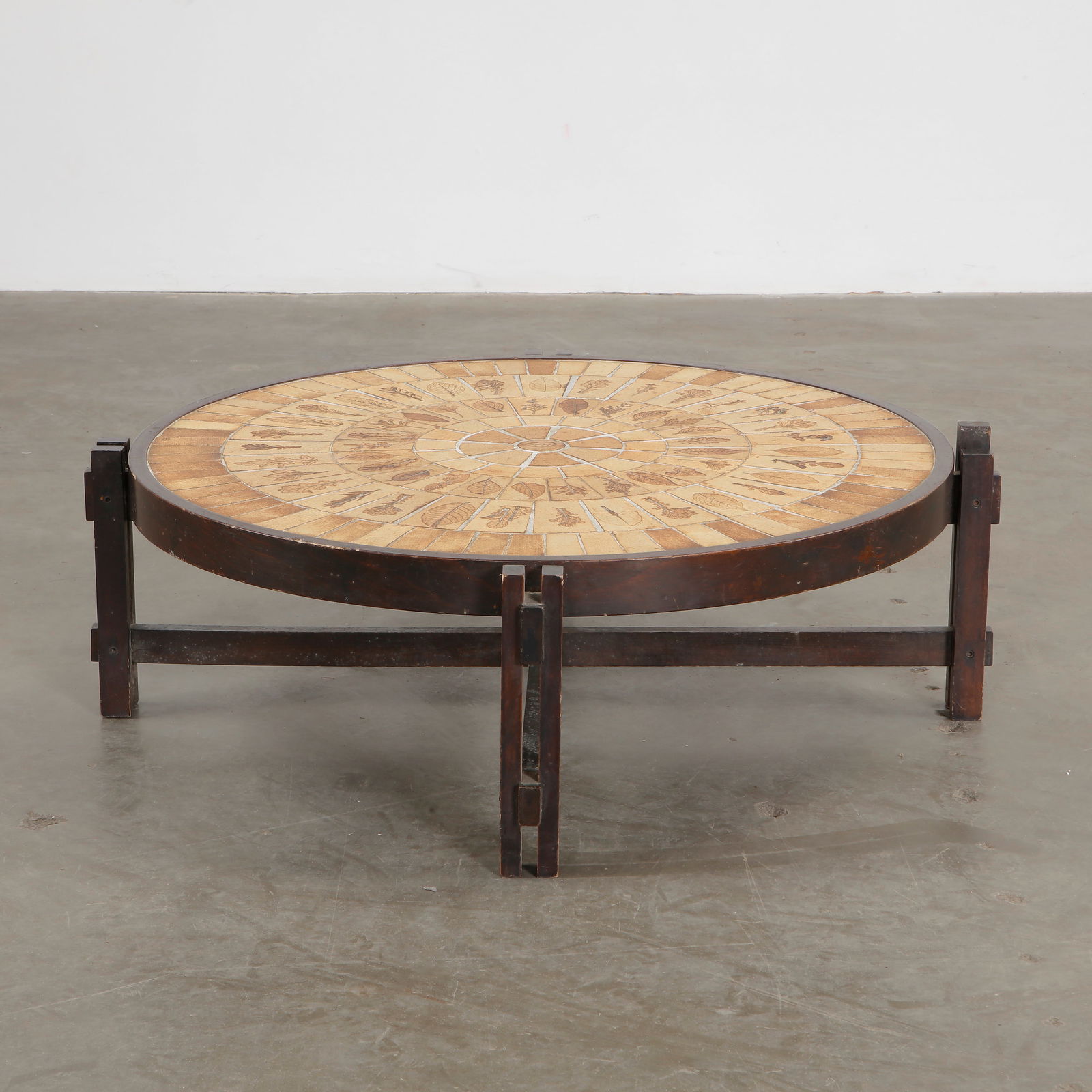Roger Capron Round Ceramic Coffee Table, 1960s: Vintage round coffee table by Roger Capron, showcasing his signature ceramic tile work with intricate natural motifs. Height: 14 in. Width: 53 in. Depth: 29 in.