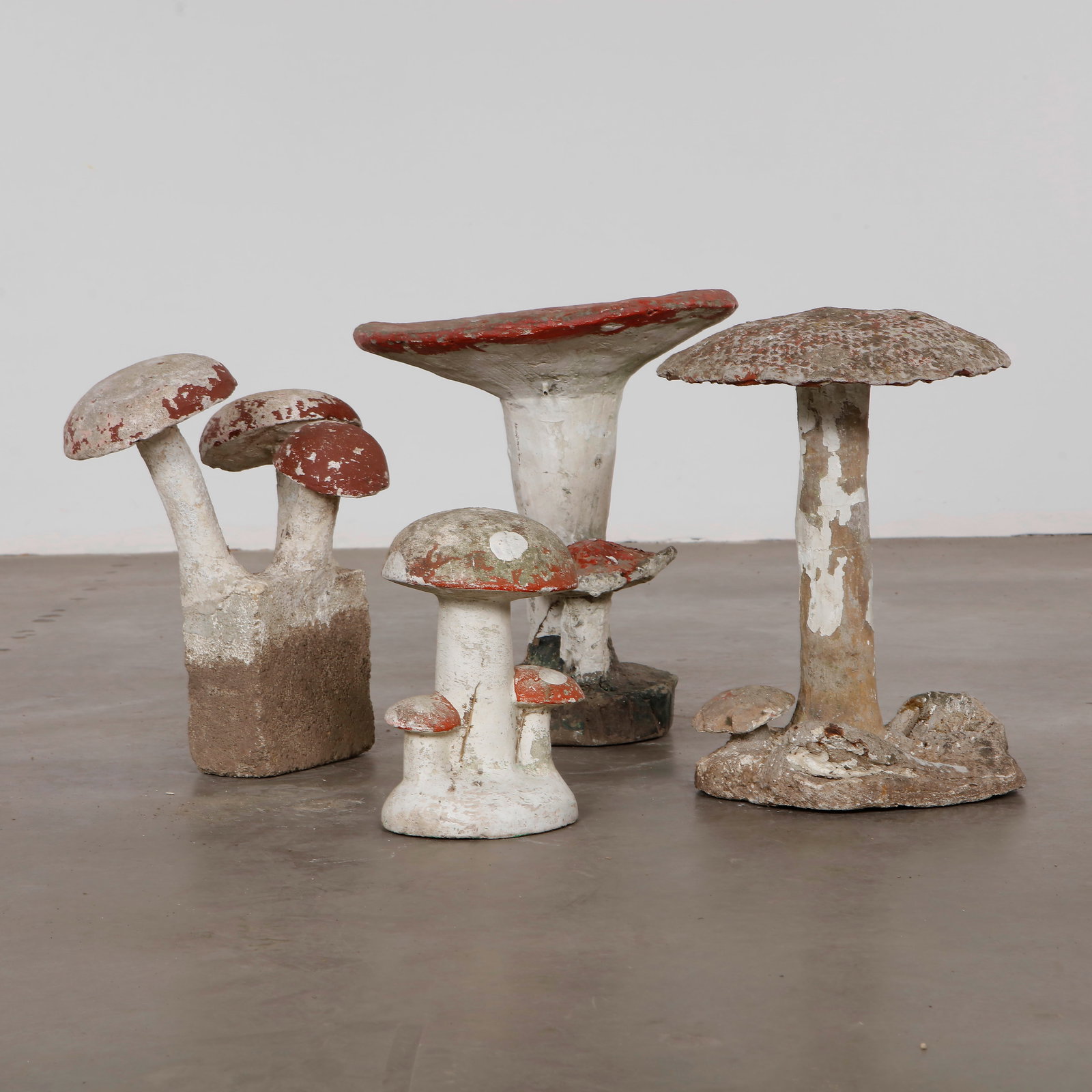 Set of Four Mushroom Sculptures, 1960s: Set of 4 sculptural concrete mushrooms, perfect for adding a whimsical and elegant touch to your garden. A playful accent for collectors of unique outdoor art. FIRST: Height: 17.5 in. Length 16 in. Wi