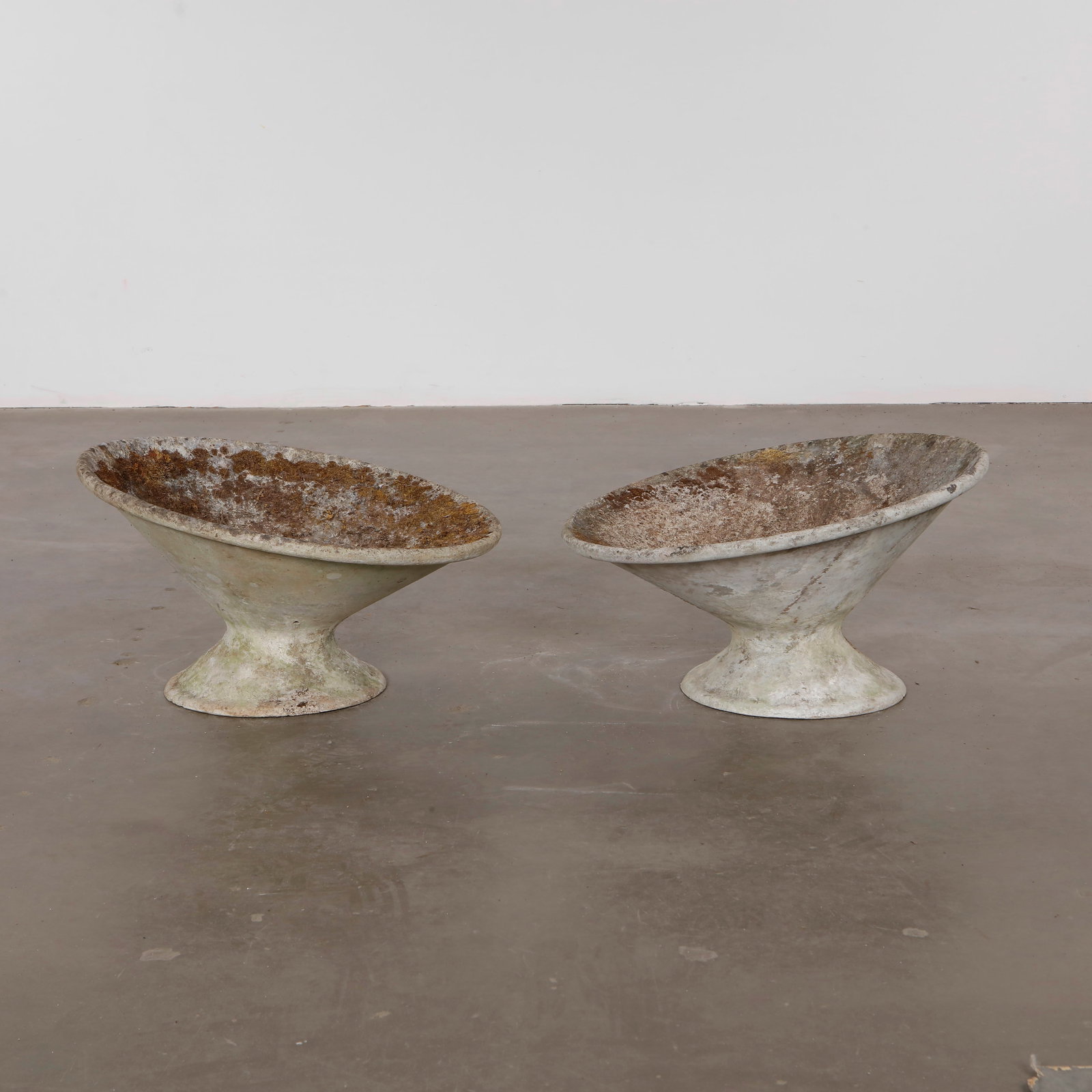 Pair of Short Willy Guhl Off Kilter Planters, 1960s: A pair of rare asymmetrical planters by Willy Guhl, featuring a bold modernist design. TOP Diameter: 25 in. BASE Diameter: 13 in. Height: 14.5 in.