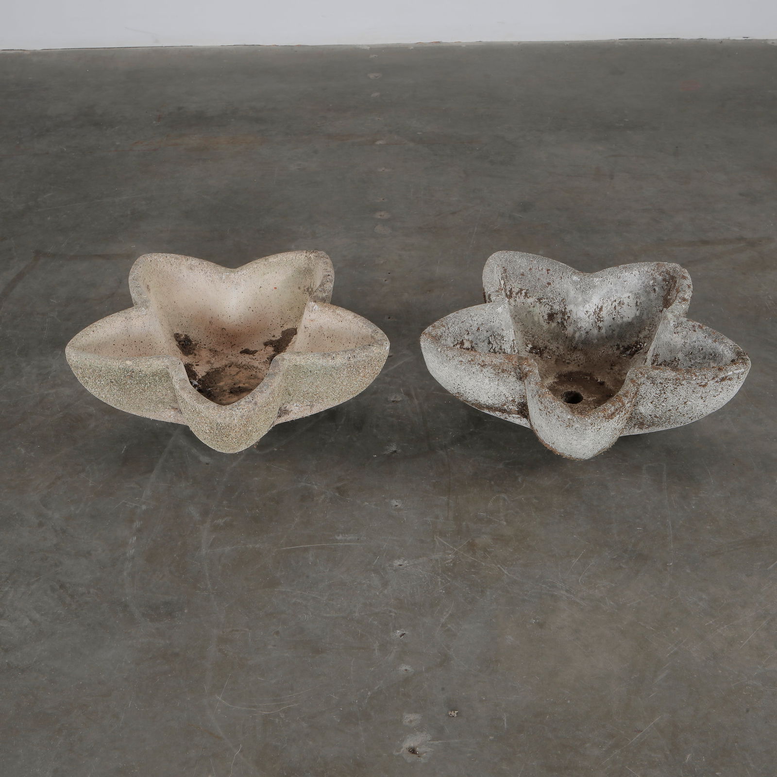Pair of Concrete Star Planters, 1960s: Pair of star-shaped planters, showcasing natural patina and sculptural form, circa 1960s. Length: 21 in. Width: 18 in. Height: 5 in.