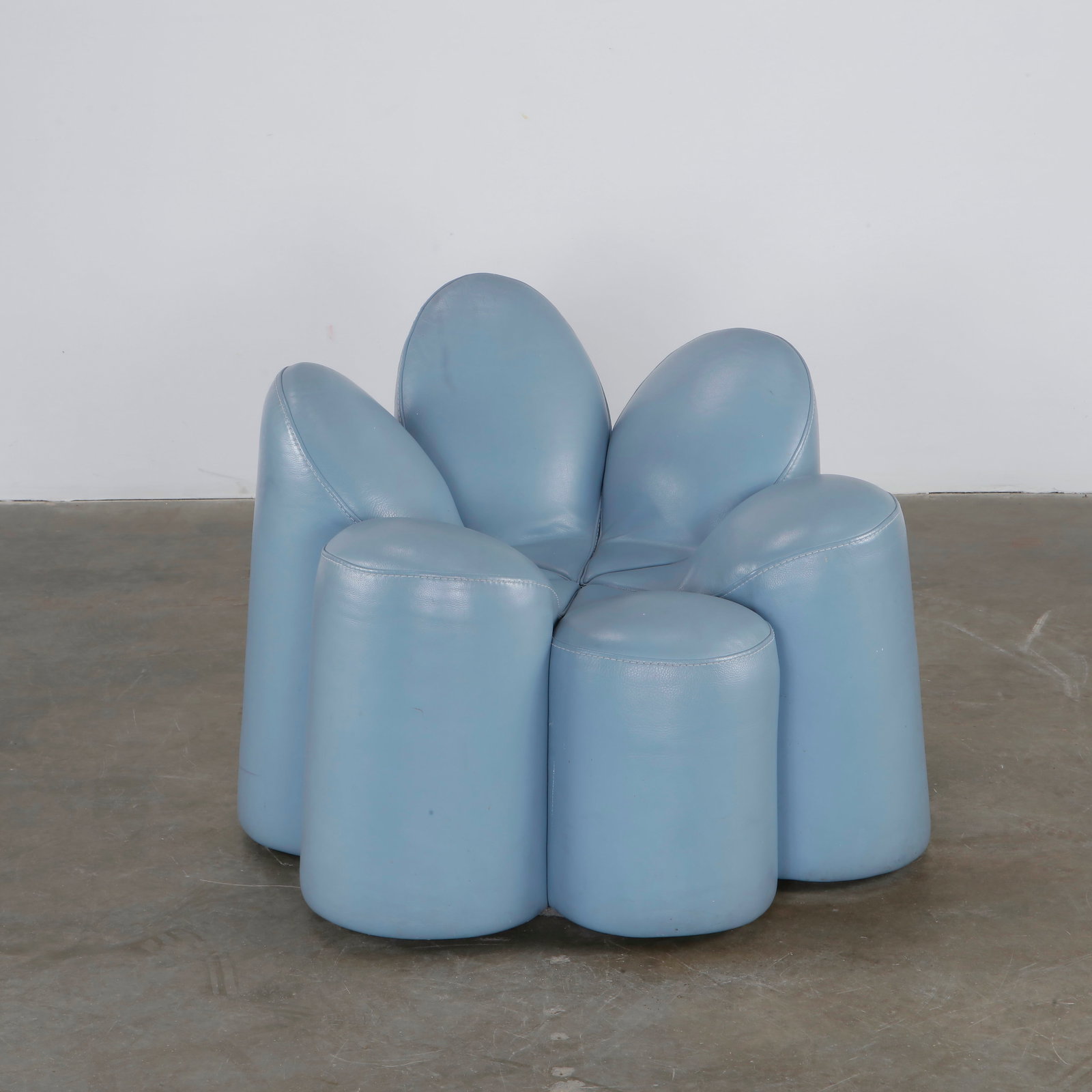 Fabrice Berrux, Blue Mayflower Chair for Roche Bobois, 2000s: A unique and sculptural armchair designed by Fabrice Berrux, featuring a petal-like design in light blue leather. Height: 32 in. Width: 35 in. Depth: 25 in.