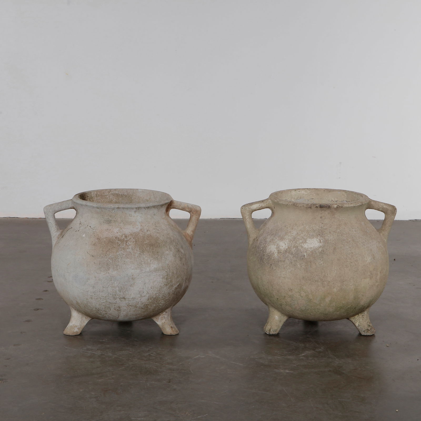 Willy Guhl, Pair of Cauldron Planters, 1960s: Rare cauldron planters by Willy Guhl, with rounded vessel-like shapes and strong sculptural presence. Aged surface adds rustic charm. Opening Diameter: 11.5 in. Overall Diameter: 21 in. Height: 18 in.